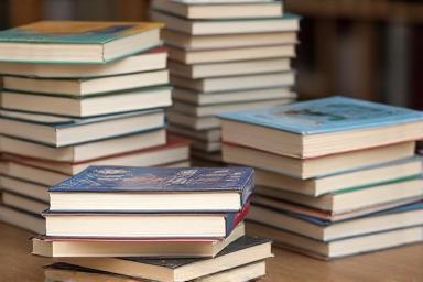 Image related to a new book release, showing a stack of books